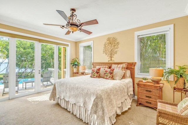 bedroom featuring ornamental molding, multiple windows, and access to exterior