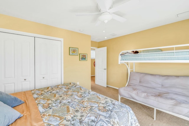 carpeted bedroom with baseboards, ceiling fan, visible vents, and a closet