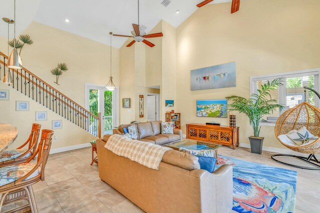 living room with baseboards, visible vents, stairway, and a ceiling fan