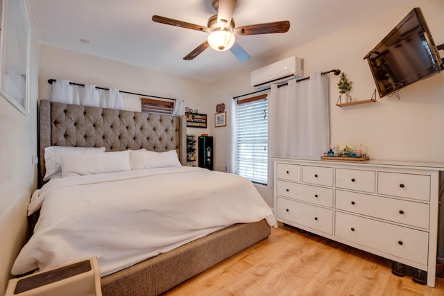15 Cactus Dr, Big Coppitt, FL 33040 - bedroom featuring a wall mounted AC, light wood-type flooring, and ceiling fan