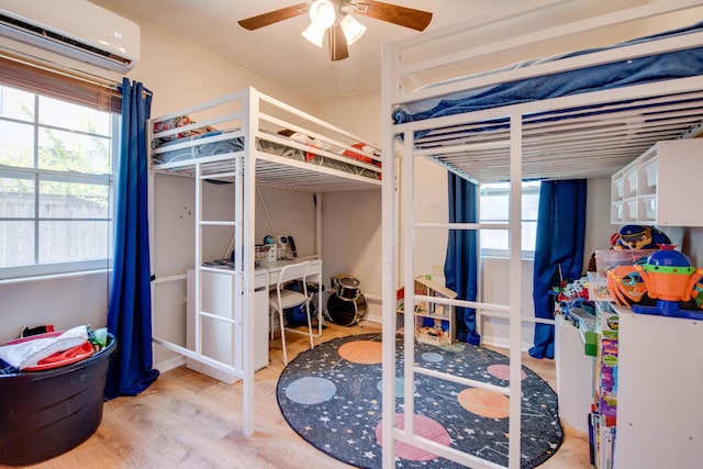 15 Cactus Dr, Big Coppitt, FL 33040 - bedroom featuring a wall mounted air conditioner, wood finished floors, and multiple windows
