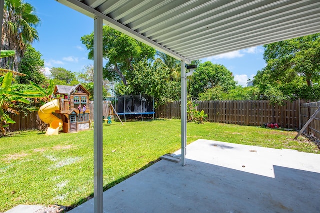 15 Cactus Dr, Big Coppitt, FL 33040 - fenced backyard featuring a playground, a trampoline, and a patio area