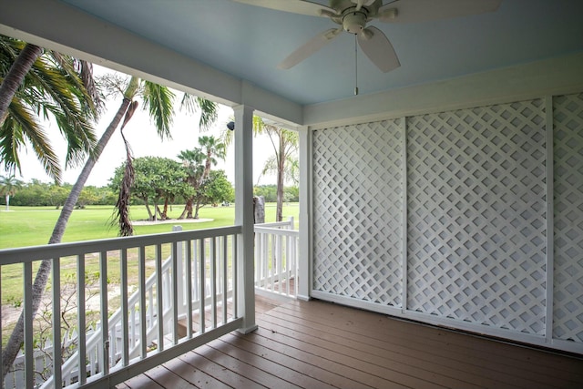 unfurnished sunroom featuring ceiling fan