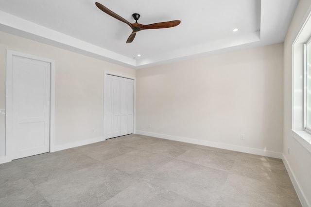 194 Buttonwood Ln, Islamorada, FL 33036 - unfurnished bedroom with a raised ceiling, two closets, recessed lighting, multiple windows, and ceiling fan