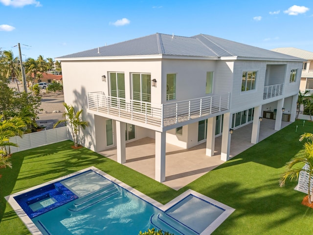 194 Buttonwood Ln, Islamorada, FL 33036 - rear view of property featuring a patio, a pool with connected hot tub, stucco siding, a balcony, and a metal roof