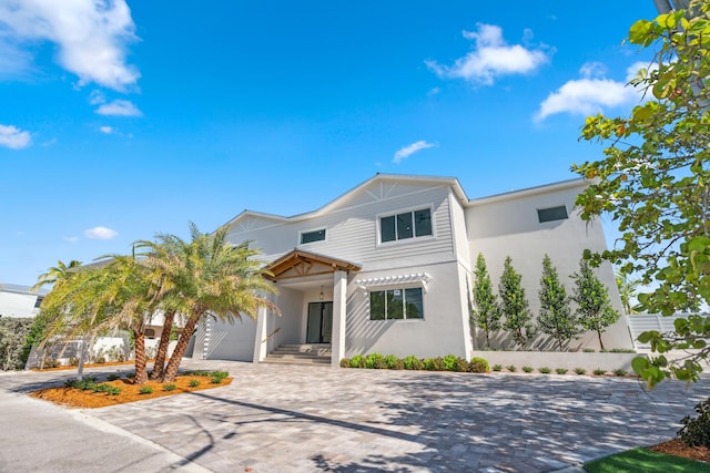 194 Buttonwood Ln, Islamorada, FL 33036 - view of front of house featuring stucco siding, driveway, and an attached garage