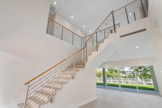 194 Buttonwood Ln, Islamorada, FL 33036 - staircase featuring a towering ceiling and recessed lighting