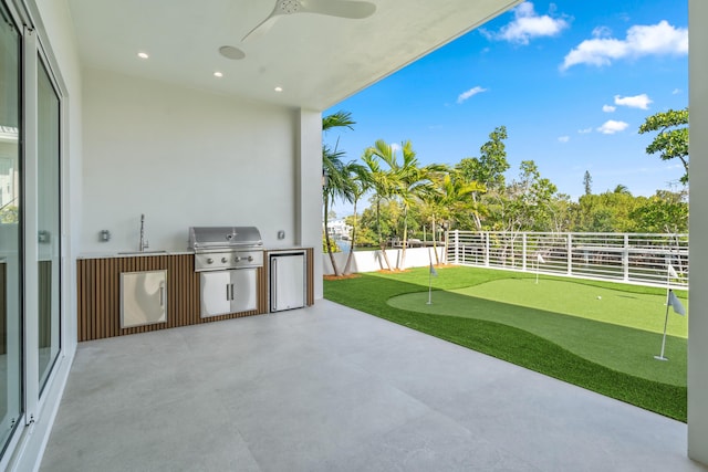 194 Buttonwood Ln, Islamorada, FL 33036 - view of patio / terrace featuring a putting area, exterior kitchen, and a ceiling fan