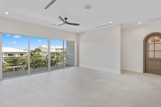 194 Buttonwood Ln, Islamorada, FL 33036 - empty room featuring a ceiling fan, concrete floors, arched walkways, and recessed lighting