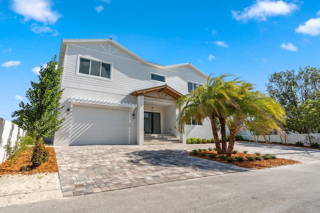194 Buttonwood Ln, Islamorada, FL 33036 - view of front facade featuring decorative driveway, an attached garage, and stucco siding
