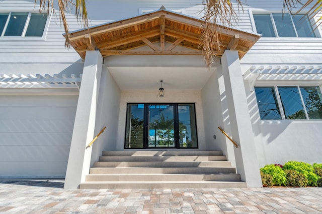 194 Buttonwood Ln, Islamorada, FL 33036 - view of exterior entry featuring stucco siding and a garage