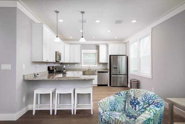 kitchen featuring white cabinetry, stainless steel appliances, kitchen peninsula, and sink