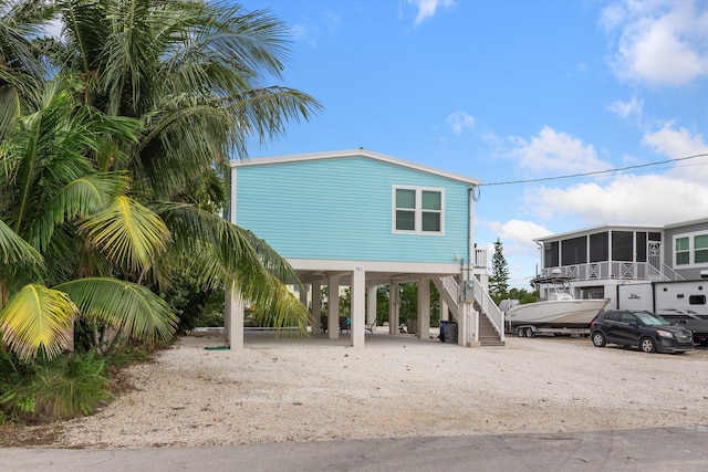 view of front of property with a carport and a sunroom