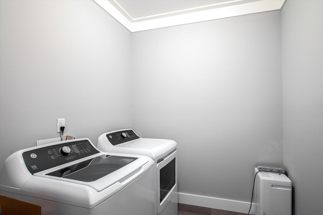 clothes washing area with washing machine and dryer