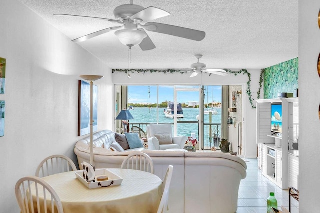 living room with ceiling fan and a textured ceiling