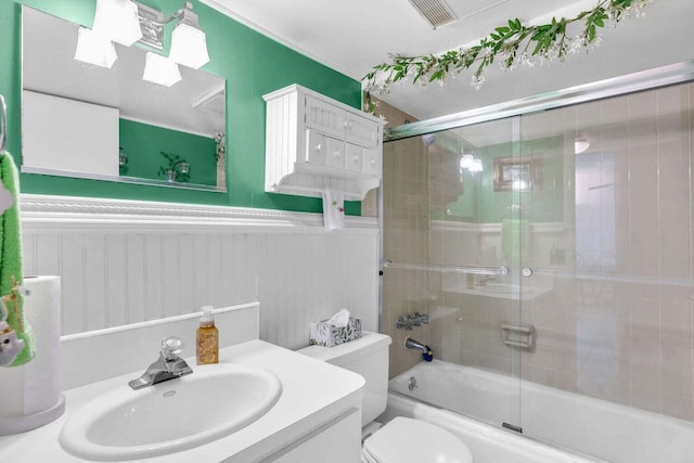 full bathroom featuring enclosed tub / shower combo, vanity, and toilet