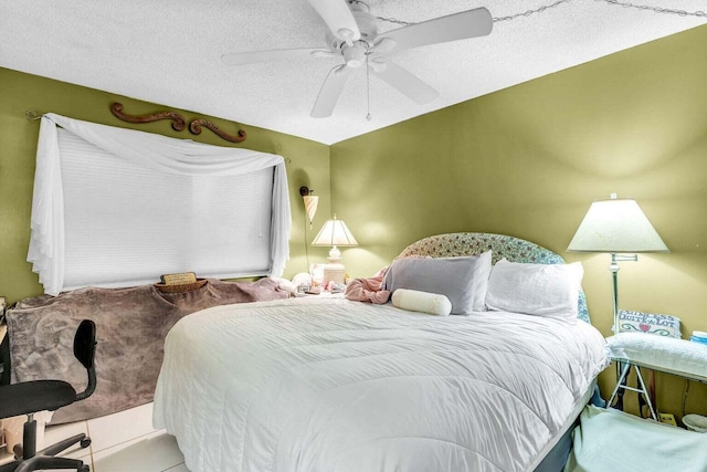 bedroom with tile patterned flooring, a textured ceiling, and ceiling fan