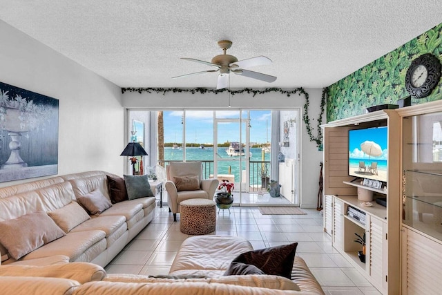 tiled living room featuring ceiling fan and a textured ceiling