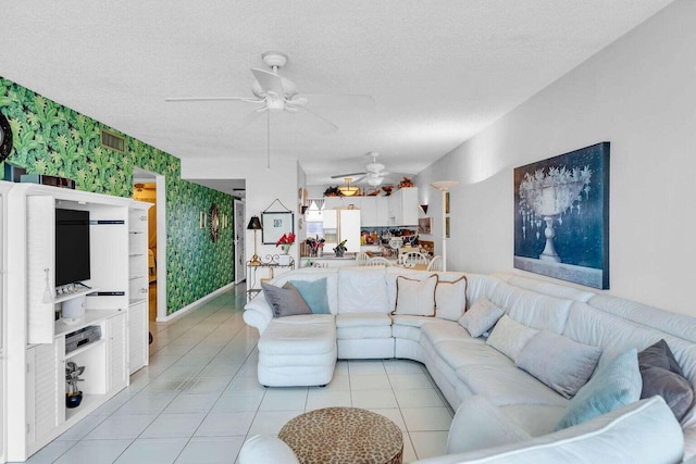 tiled living room with ceiling fan and a textured ceiling