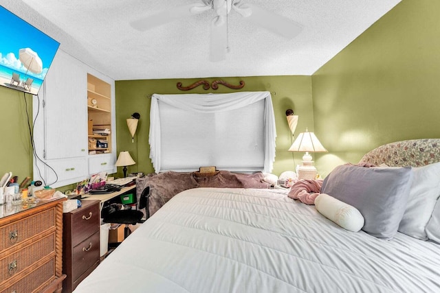 bedroom with ceiling fan and a textured ceiling