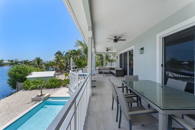 view of patio with ceiling fan, a water view, an outdoor hangout area, outdoor dining space, and an outdoor pool