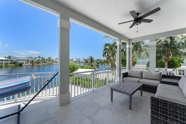 view of patio / terrace featuring outdoor lounge area, a balcony, a ceiling fan, and a water view