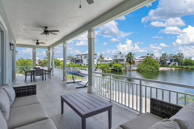 exterior space with a residential view, a water view, ceiling fan, and outdoor dining space