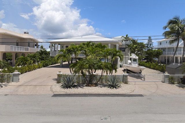 view of front of property with fence, driveway, and a gate