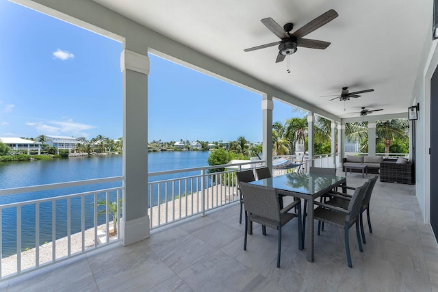 view of patio / terrace featuring an outdoor living space, a water view, ceiling fan, and outdoor dining space