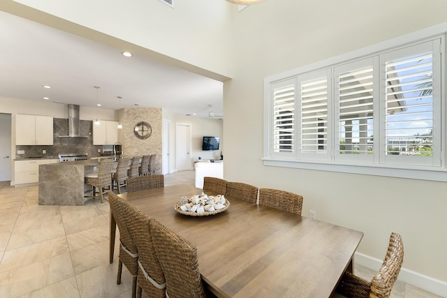 dining space featuring recessed lighting and baseboards