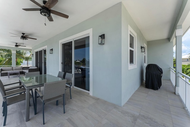 view of patio with outdoor dining area, a ceiling fan, and grilling area