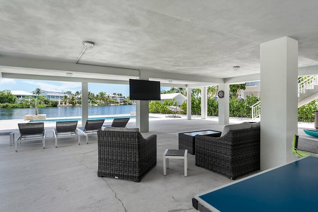 view of patio featuring an outdoor pool and a water view