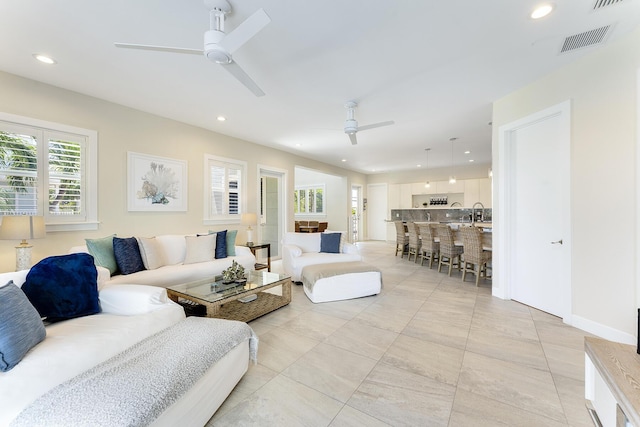 living room featuring visible vents, recessed lighting, and a ceiling fan