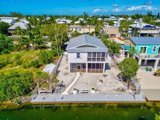 bird's eye view featuring a water view and a residential view