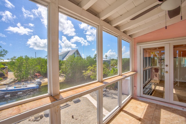 sunroom / solarium featuring vaulted ceiling with beams and ceiling fan