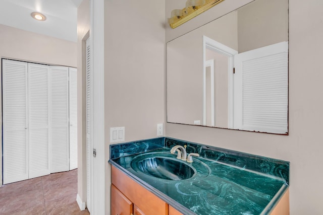 bathroom with recessed lighting, a closet, vanity, and tile patterned floors