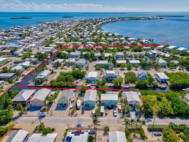 drone / aerial view featuring a water view and a residential view