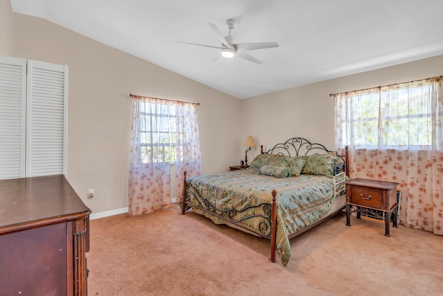 carpeted bedroom featuring lofted ceiling, baseboards, and a ceiling fan