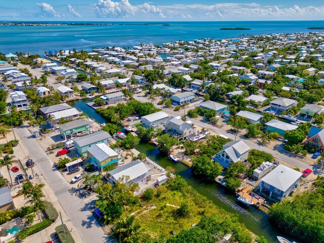 drone / aerial view with a water view and a residential view