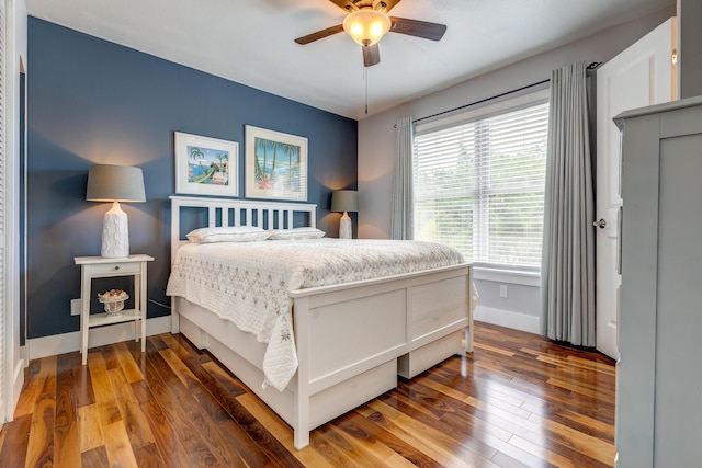 bedroom with ceiling fan and dark hardwood / wood-style flooring