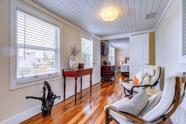 living area featuring hardwood / wood-style flooring and wood ceiling