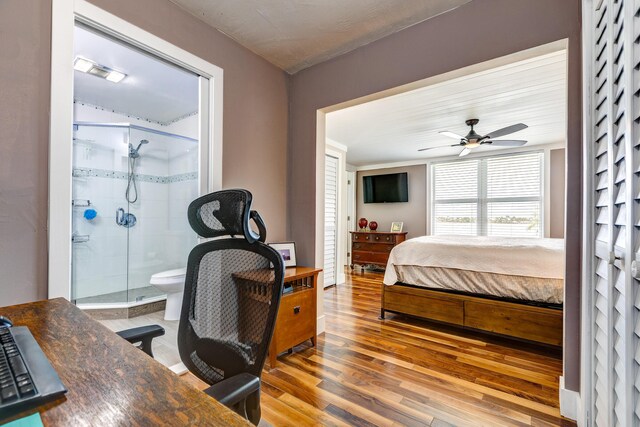 bedroom featuring ensuite bathroom and hardwood / wood-style floors