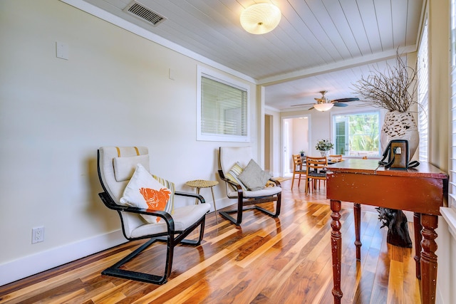 recreation room with ornamental molding, hardwood / wood-style floors, and wooden ceiling