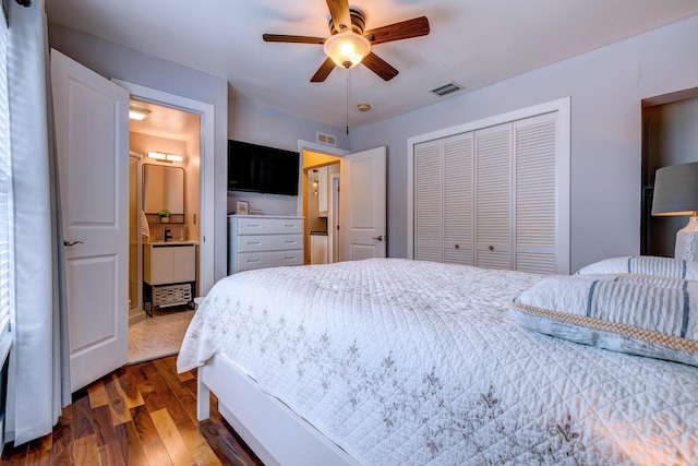 bedroom featuring ceiling fan, ensuite bathroom, dark hardwood / wood-style flooring, and a closet