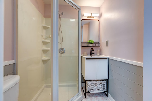 bathroom with vanity, a shower with shower door, and toilet