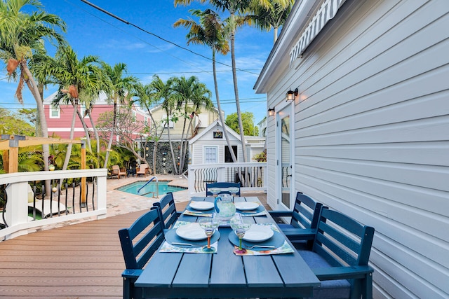 wooden deck featuring a fenced in pool