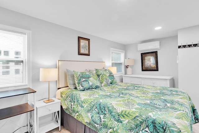 bedroom with radiator, a wall mounted AC, recessed lighting, and wood finished floors