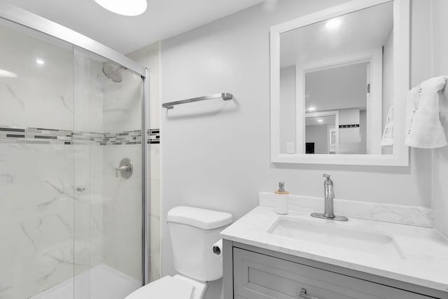 full bath featuring vanity, toilet, and a shower stall