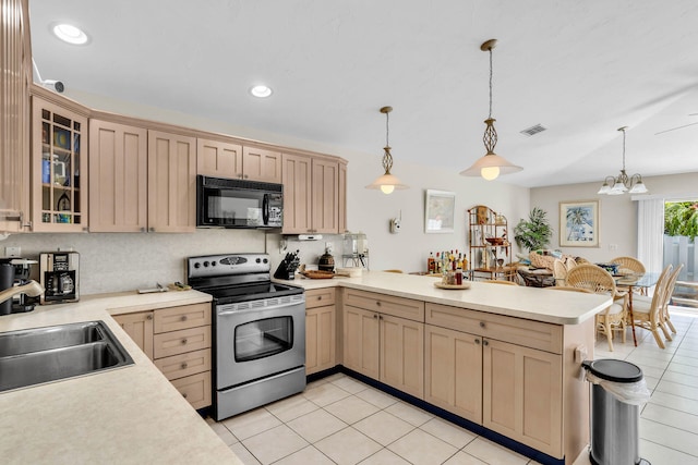 120 9th St, Key Colony, FL 33051 - kitchen featuring black microwave, stainless steel range with electric cooktop, light countertops, a peninsula, and light tile patterned flooring
