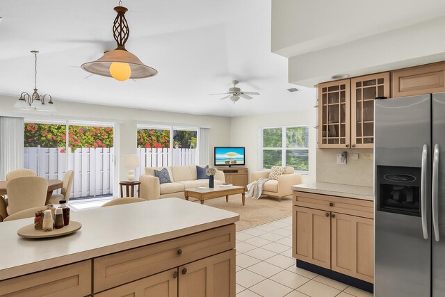 120 9th St, Key Colony, FL 33051 - kitchen with stainless steel refrigerator with ice dispenser, light tile patterned flooring, light countertops, and glass insert cabinets